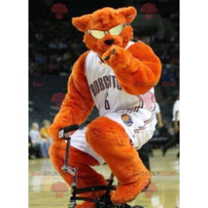 Orange bear mascot with glasses in basketball outfit -