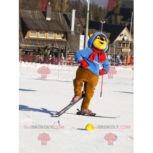 Brown and yellow bear mascot in ski outfit. Winter teddy bear -