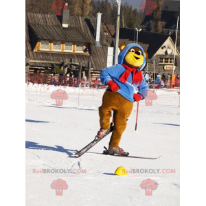 Mascote urso marrom e amarelo com roupa de esqui. Ursinho de