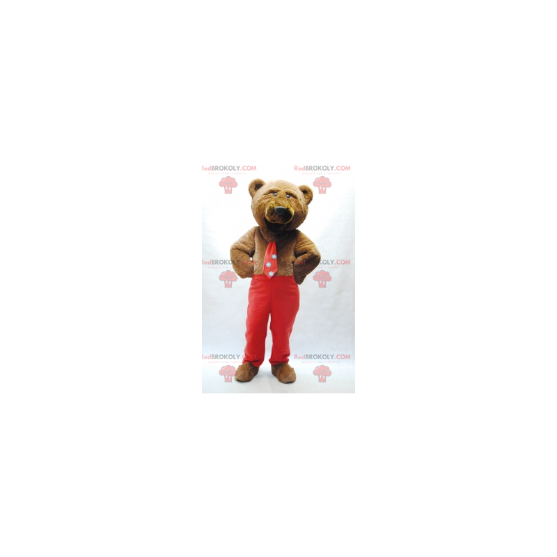 Mascotte d'ours brun avec une cravate et un pantalon rouge -