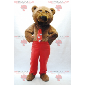 Mascotte orso bruno con cravatta e pantaloni rossi -
