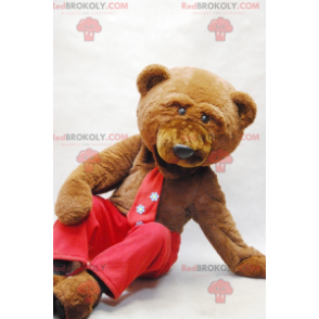 Mascotte orso bruno con cravatta e pantaloni rossi -