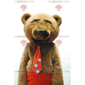 Mascotte orso bruno con cravatta e pantaloni rossi -