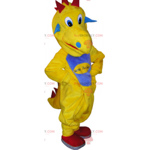 Gul dinosaurie maskot med en blå mage - Redbrokoly.com