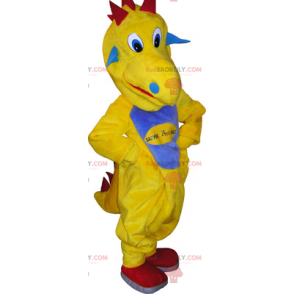Gelbes Dinosaurier-Maskottchen mit einem blauen Bauch -