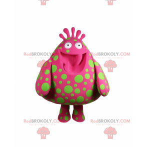 Mascotte de personnage rose avec des taches vertes -