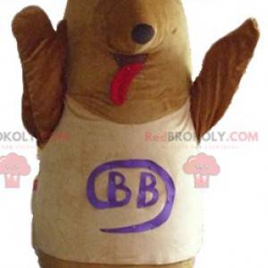 Brązowo-beżowy pies maskotka z kokardą na głowie -