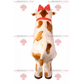 Mascote vaca com laço e sino vermelhos - Redbrokoly.com