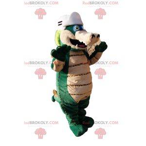 Mascota dinosaurio verde y beige con casco de béisbol