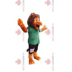 Mascotte leone arancione con abbigliamento sportivo verde e nero