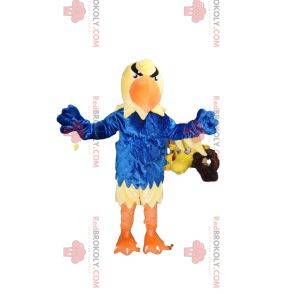 Mascotte d'aigle jaune avec un maillot bleu