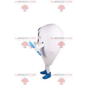 Smiling white tooth mascot and blue toothbrush