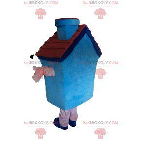 Blå husmaskot med en lille pejs