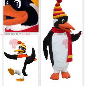 Mascot cute white and black penguin dressed in winter clothes -