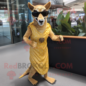 Gold Thylacosmilus mascot costume character dressed with a Shift Dress and Sunglasses