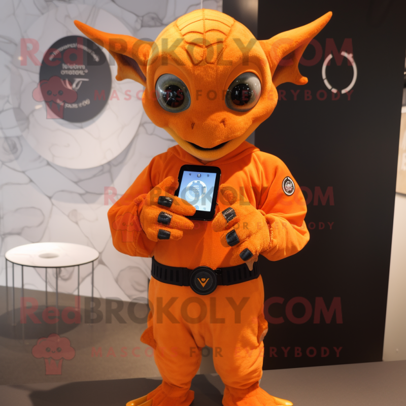 Orange Gargoyle mascot costume character dressed with a Long Sleeve Tee and Smartwatches