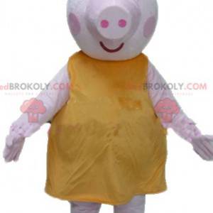 Mascotte de gros cochon rose avec une robe jaune dodu et drôle