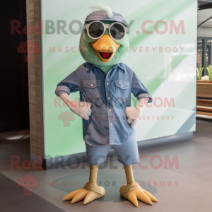 Green Goose mascot costume character dressed with a Chambray Shirt and Sunglasses