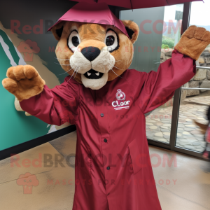 Maroon Mountain Lion mascot costume character dressed with a Raincoat and Cufflinks