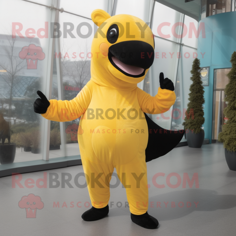 Yellow Killer Whale mascot costume character dressed with a Yoga Pants and Mittens Yellow Killer Whale mascot costume character dressed with a Yoga Pants and Mittens