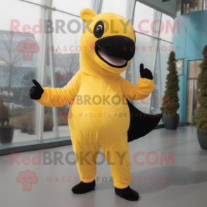 Yellow Killer Whale mascot costume character dressed with a Yoga Pants and Mittens