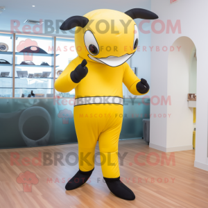 Yellow Killer Whale mascot costume character dressed with a Yoga Pants and Mittens