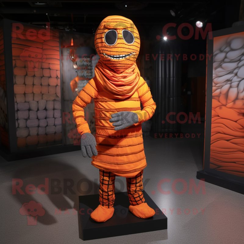 Orange Mummy mascot costume character dressed with a Flannel Shirt and Foot pads Orange Mummy mascot costume character dressed with a Flannel Shirt and Foot pads
