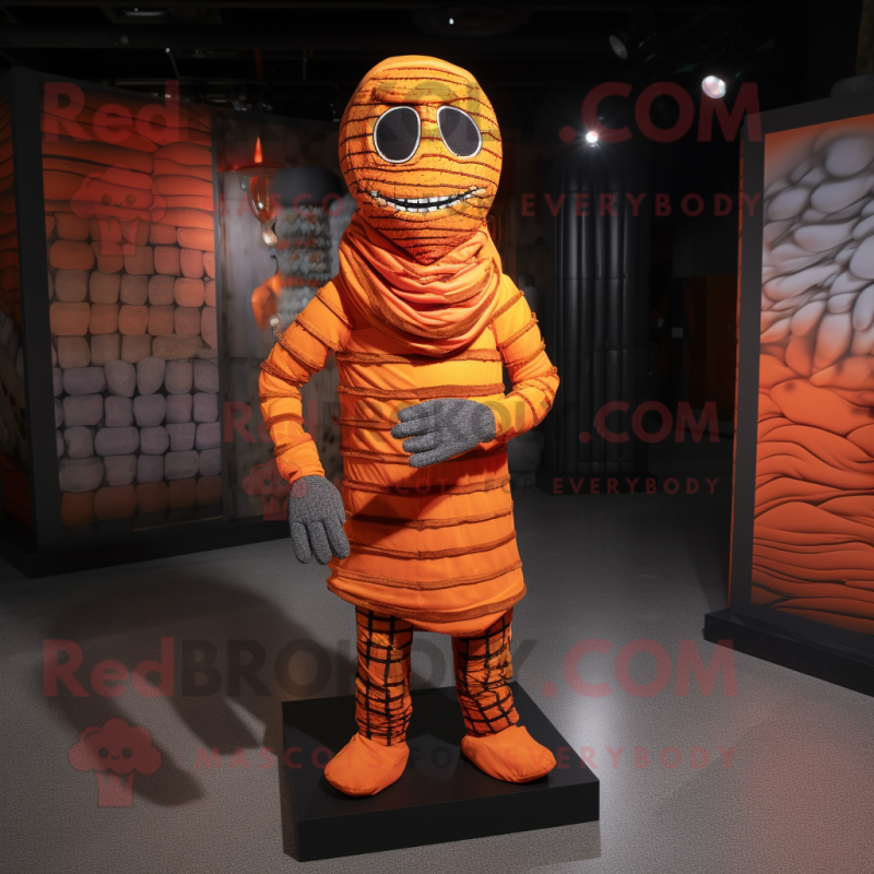 Orange Mummy mascot costume character dressed with a Flannel Shirt and Foot pads