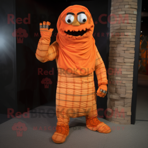 Orange Mummy mascot costume character dressed with a Flannel Shirt and Foot pads