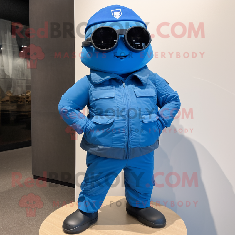 Blue Para Commando mascot costume character dressed with a Jacket and Eyeglasses Blue Para Commando mascot costume character dressed with a Jacket and Eyeglasses