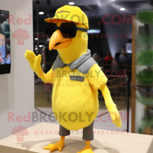 Lemon Yellow Woodpecker mascot costume character dressed with a T-Shirt and Sunglasses