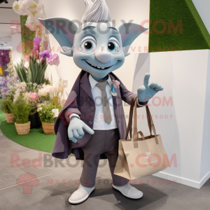 Gray Tooth Fairy mascot costume character dressed with a Blazer and Tote bags