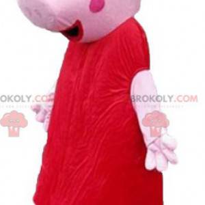 Różowa maskotka świnia ubrana w czerwoną sukienkę -