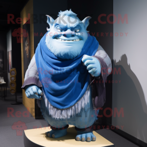 Blue Ogre mascot costume character dressed with a T-Shirt and Shawl pins