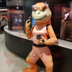 Peach Komodo Dragon mascot costume character dressed with a Bikini and Smartwatches