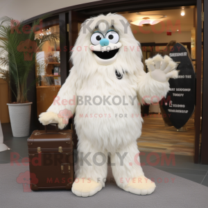 Cream Yeti mascot costume character dressed with a Suit Pants and Handbags