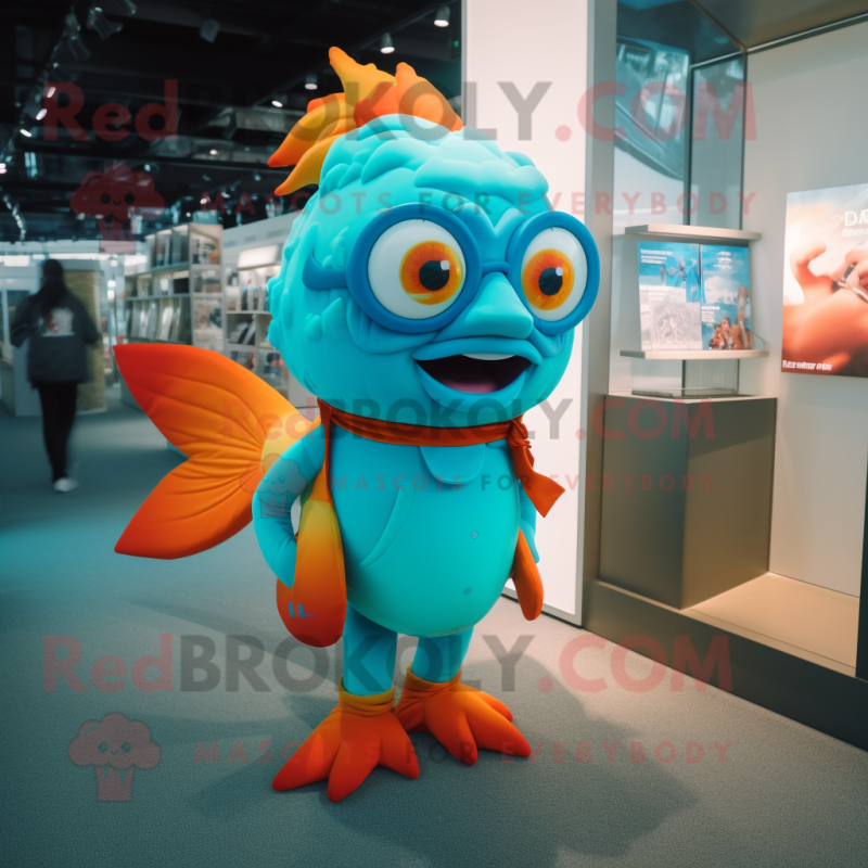 Turquoise Goldfish mascot costume character dressed with a Graphic Tee and Eyeglasses