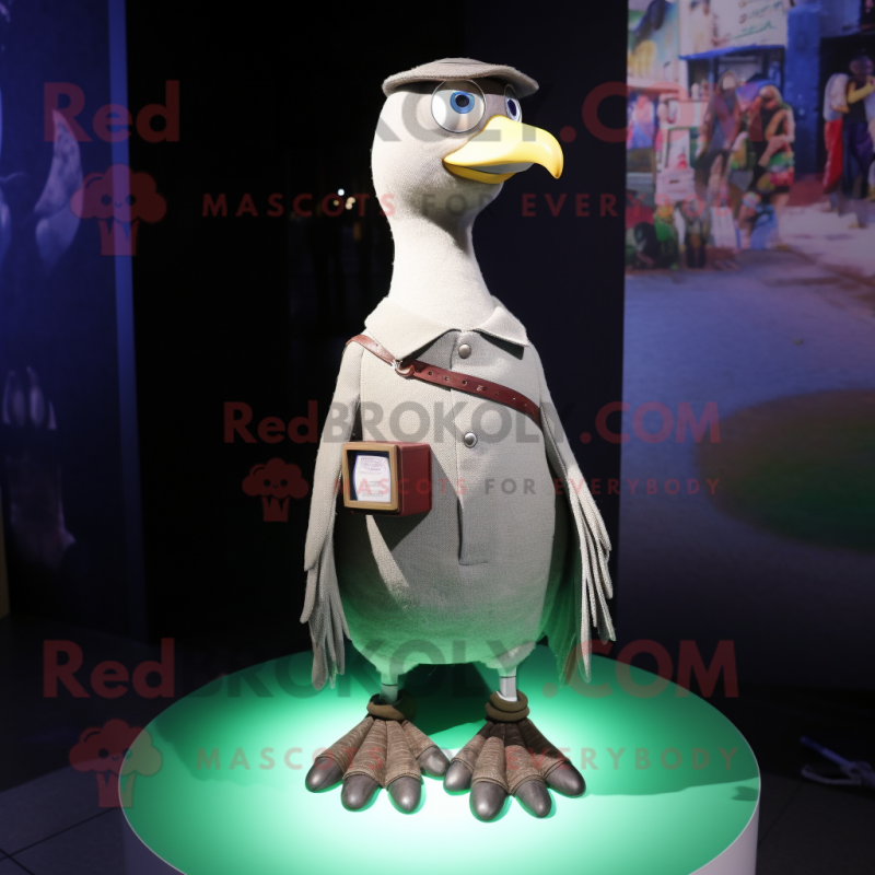 Olive Pigeon mascot costume character dressed with a Bootcut Jeans and Shawl pins Olive Pigeon mascot costume character dressed with a Bootcut Jeans and Shawl pins