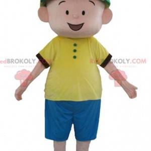 Mascotte de garçon en tenue bleue et jaune avec un chapeau vert