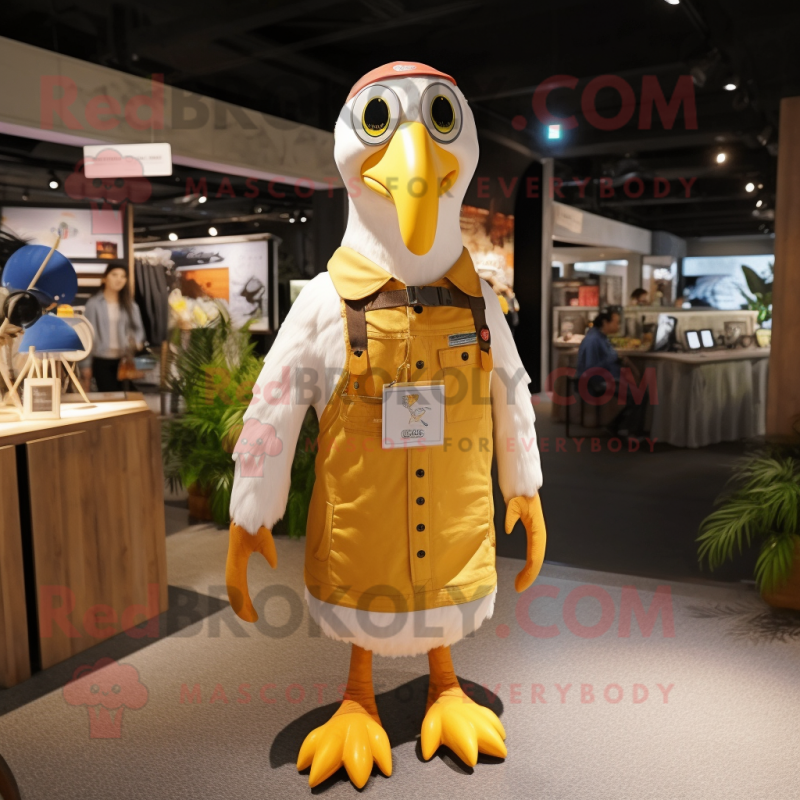 Gold Albatross mascot costume character dressed with a Overalls and Keychains