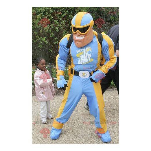 Mascote do super-herói em traje azul e amarelo - Redbrokoly.com