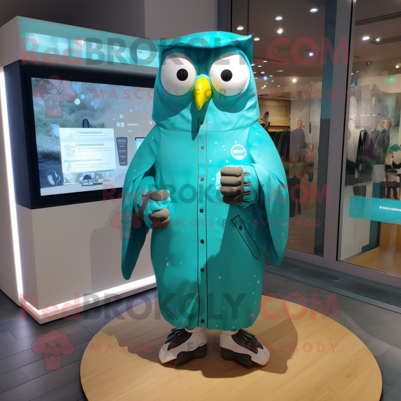 Turquoise Owl mascot costume character dressed with a Raincoat and Smartwatches Turquoise Owl mascot costume character dressed with a Raincoat and Smartwatches