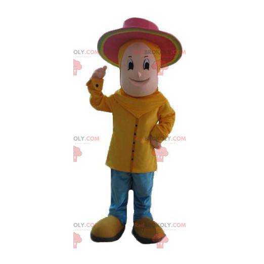 Mascotte de garçon habillé en jaune avec un chapeau rose -