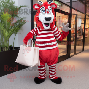 Red Zebra mascot costume character dressed with a Dress Pants and Tote bags