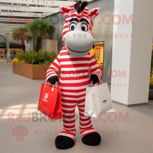 Red Zebra mascot costume character dressed with a Dress Pants and Tote bags