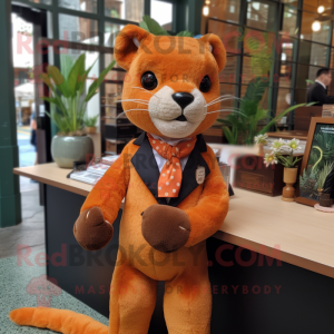 Orange Jaguarundi mascot costume character dressed with a Romper and Tie pins