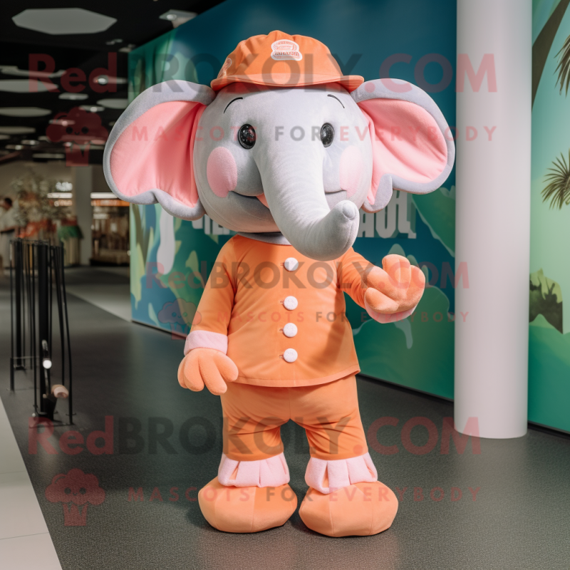 Peach Elephant mascot costume character dressed with a Playsuit and Hats Peach Elephant mascot costume character dressed with a Playsuit and Hats