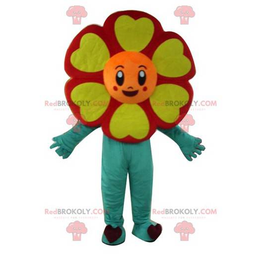 Very smiling red orange yellow and green flower mascot -
