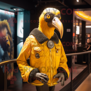 Gold Vulture mascot costume character dressed with a Bomber Jacket and Shawl pins