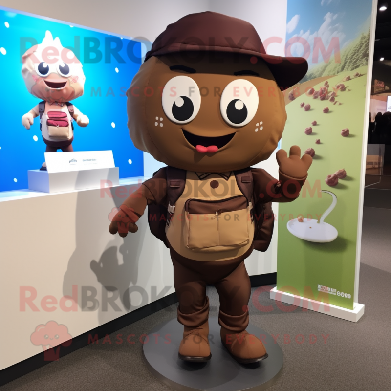 Brown Cupcake mascot costume character dressed with a Windbreaker and Backpacks Brown Cupcake mascot costume character dressed with a Windbreaker and Backpacks